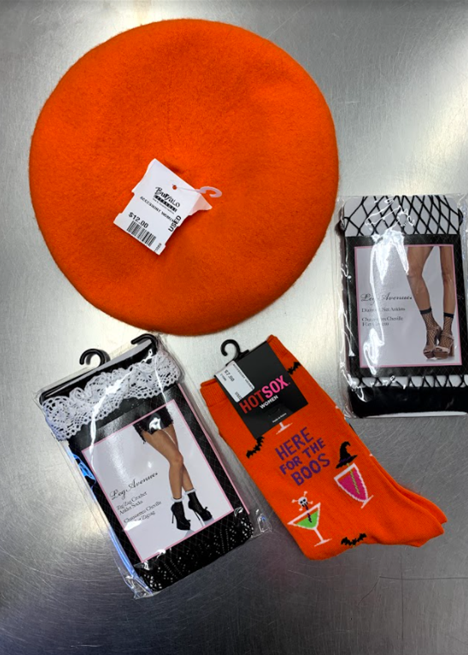 Orange beret , fishnet socks, doily socks and Halloween socks that say Here for the Boos