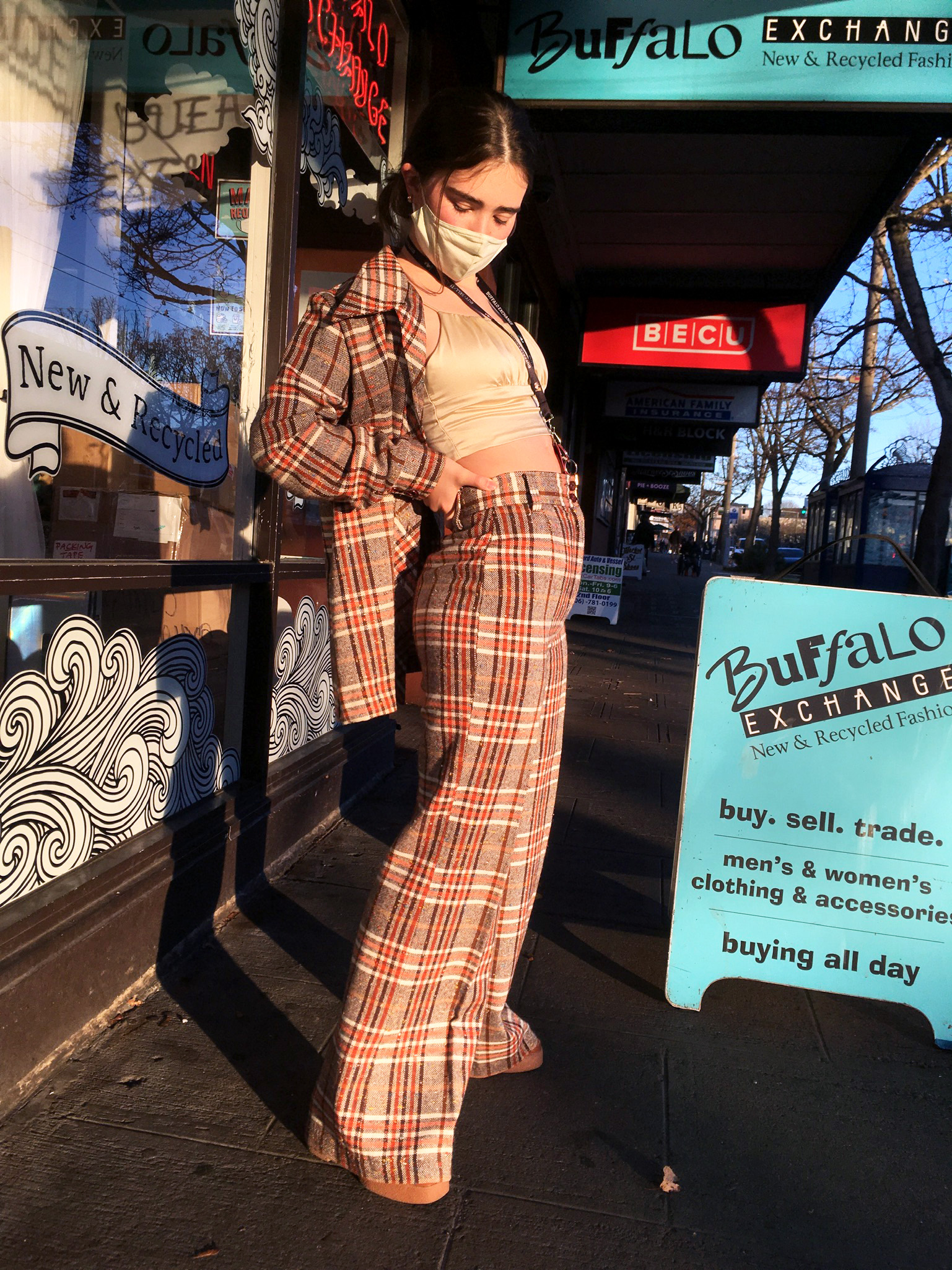 A person wearing an orange and beige two piece plaid suit