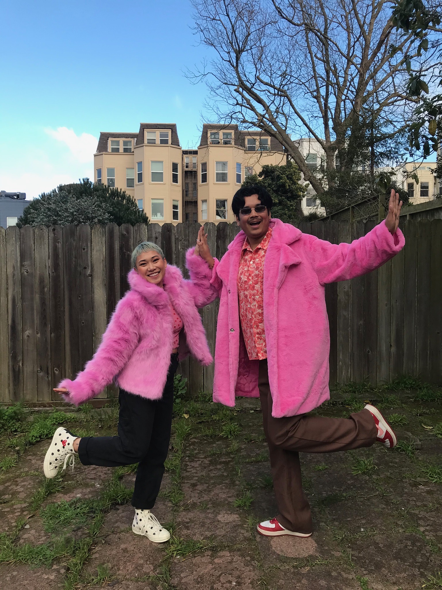 Two people wearing matching fuschia coats