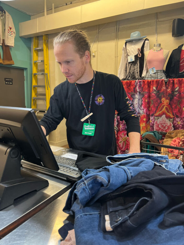 Buffalo Exchange employee buying a clothing item for the store