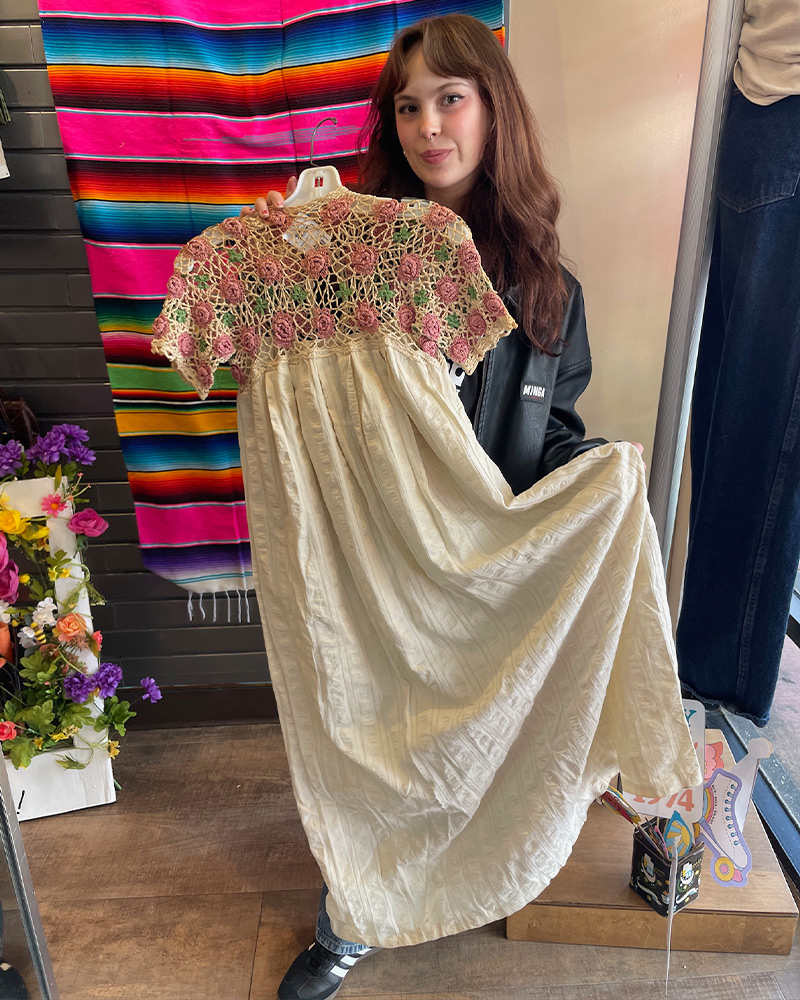 Customer holding up white dress