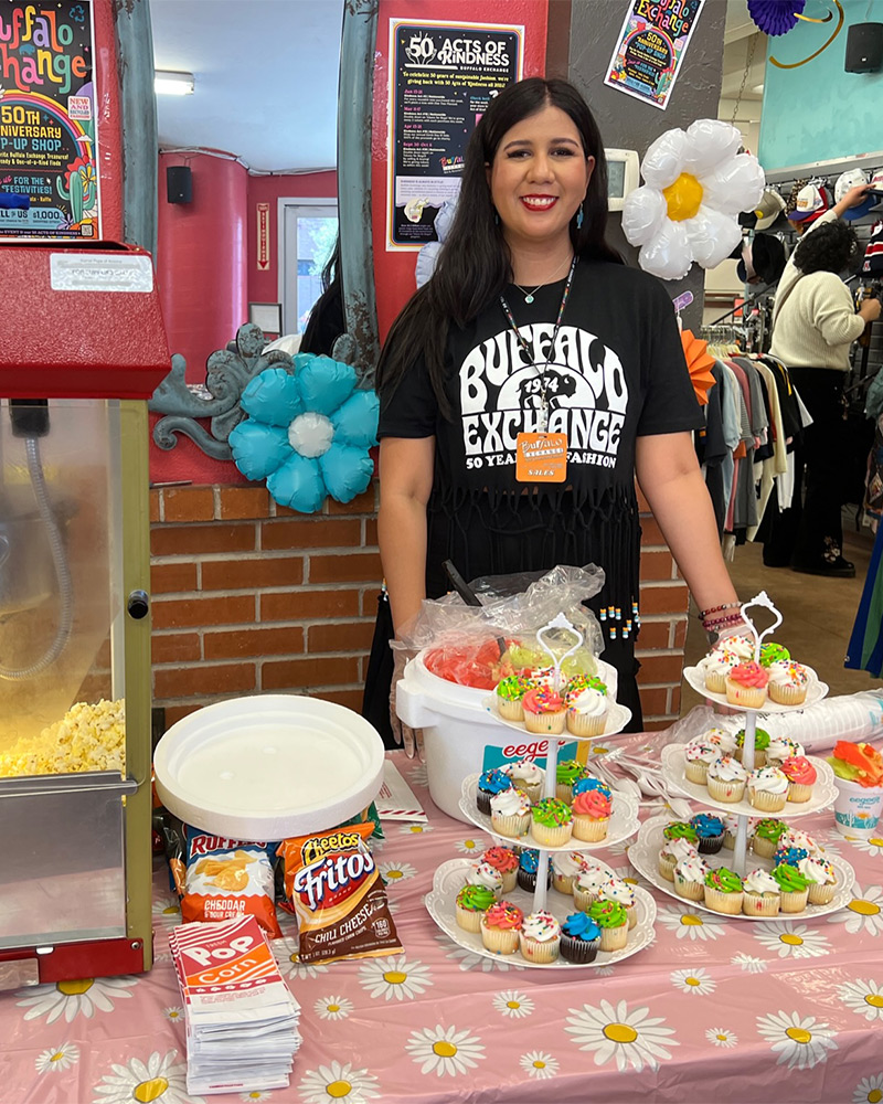 Employee standing behind 50th snack table