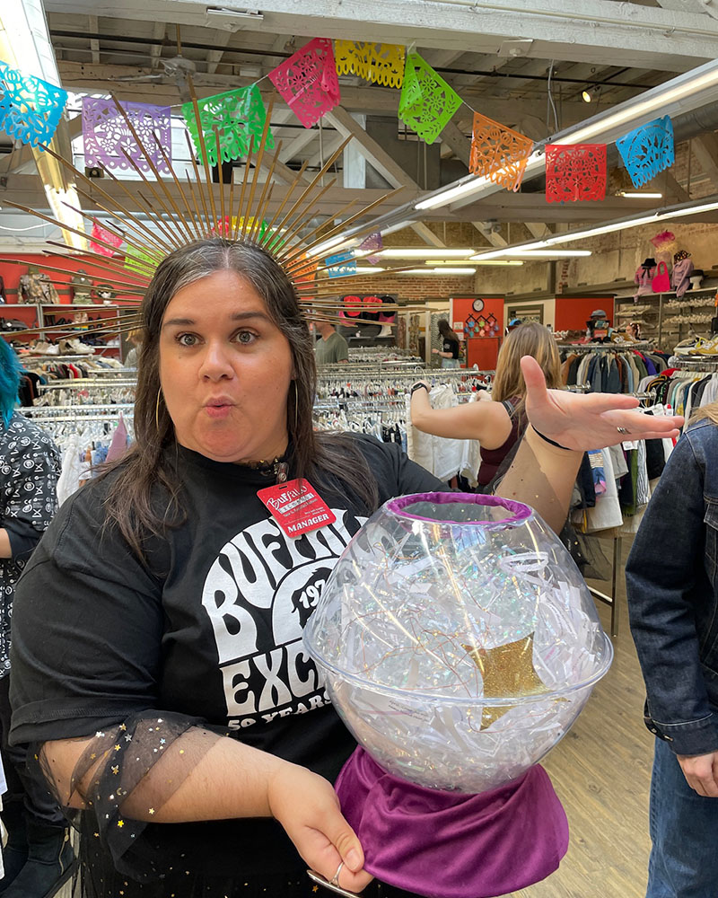 Woman holding faux crystal ball to tell fashion fortunes