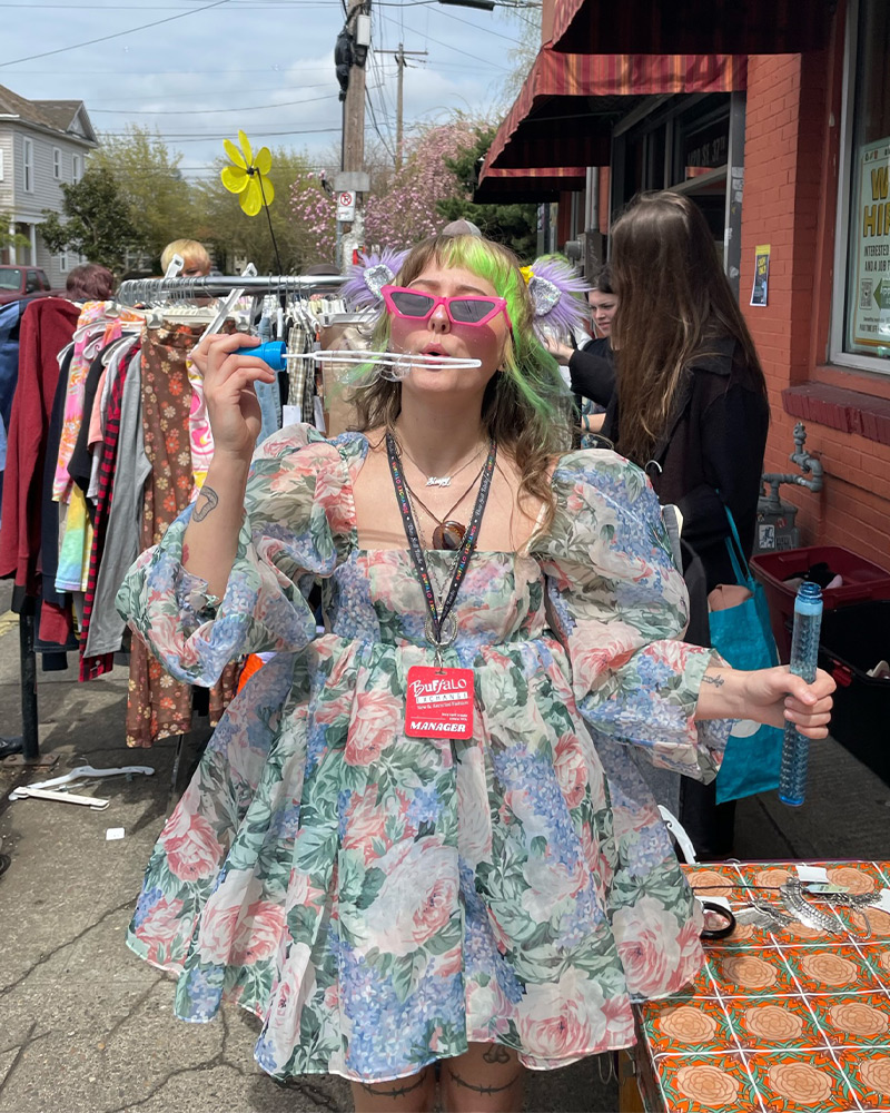 Manager having fun blowing bubbles at the $1 sale