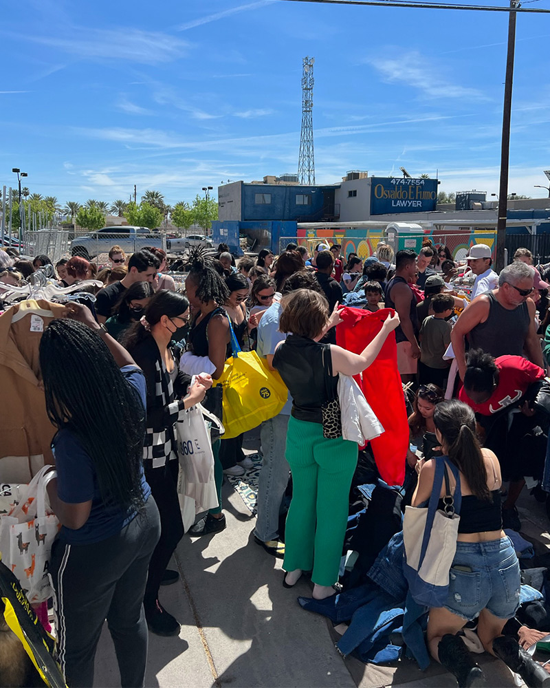 Customers looking through clothes at the $1 sale