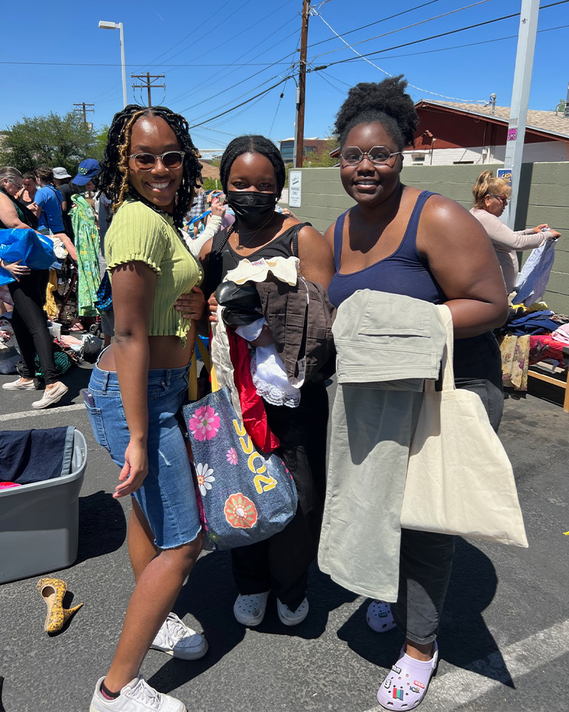 Group of three friends shopping the $1 sale