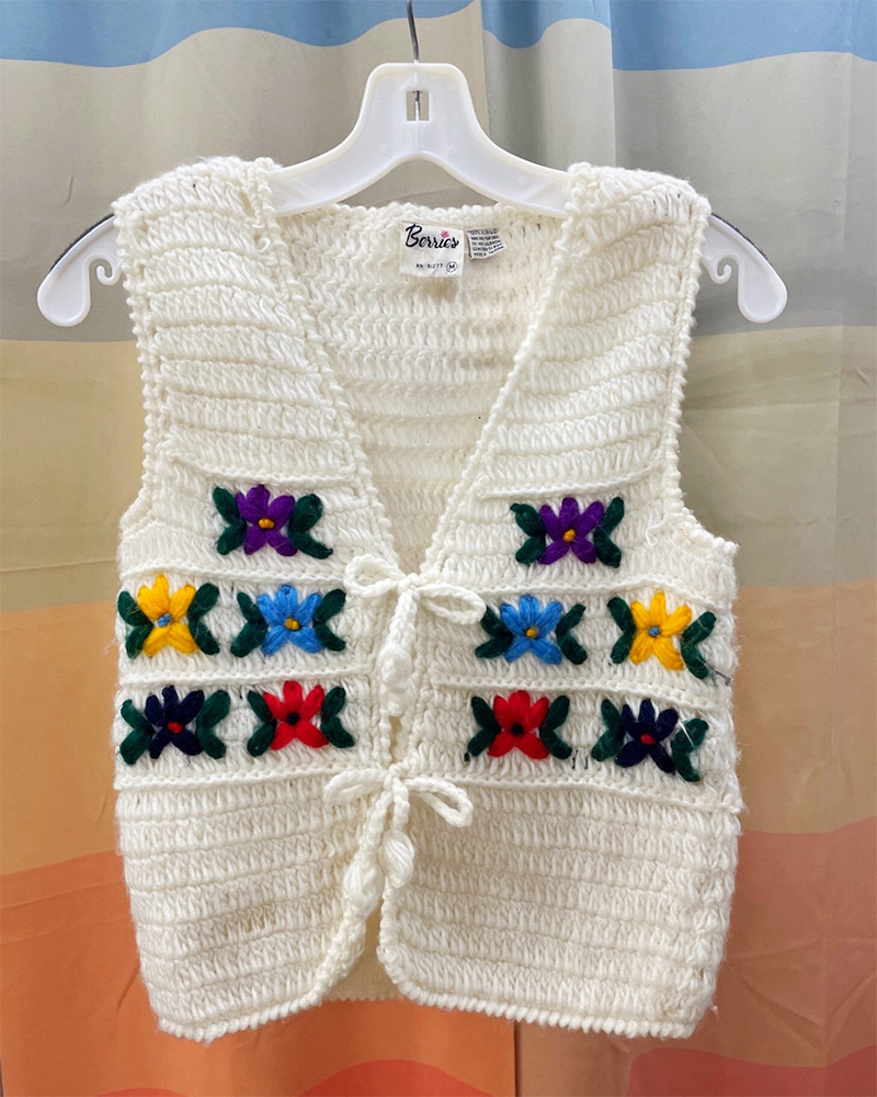 White sweater vest with rainbow flower details