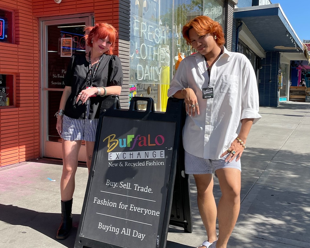 Two Buffalo employees next to the sign