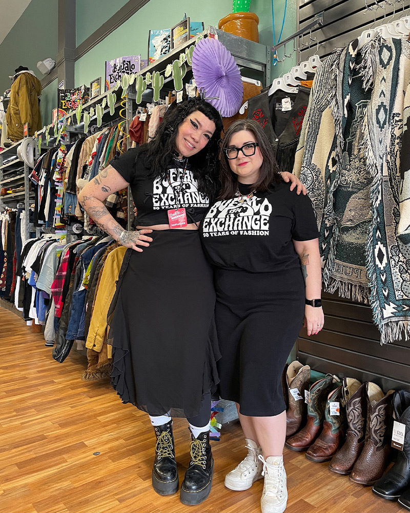 Two employees in matching Buffalo tees 