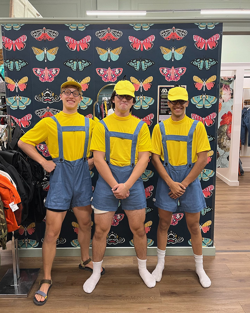 Three men dressed as Minions from the Despicable Me franchise