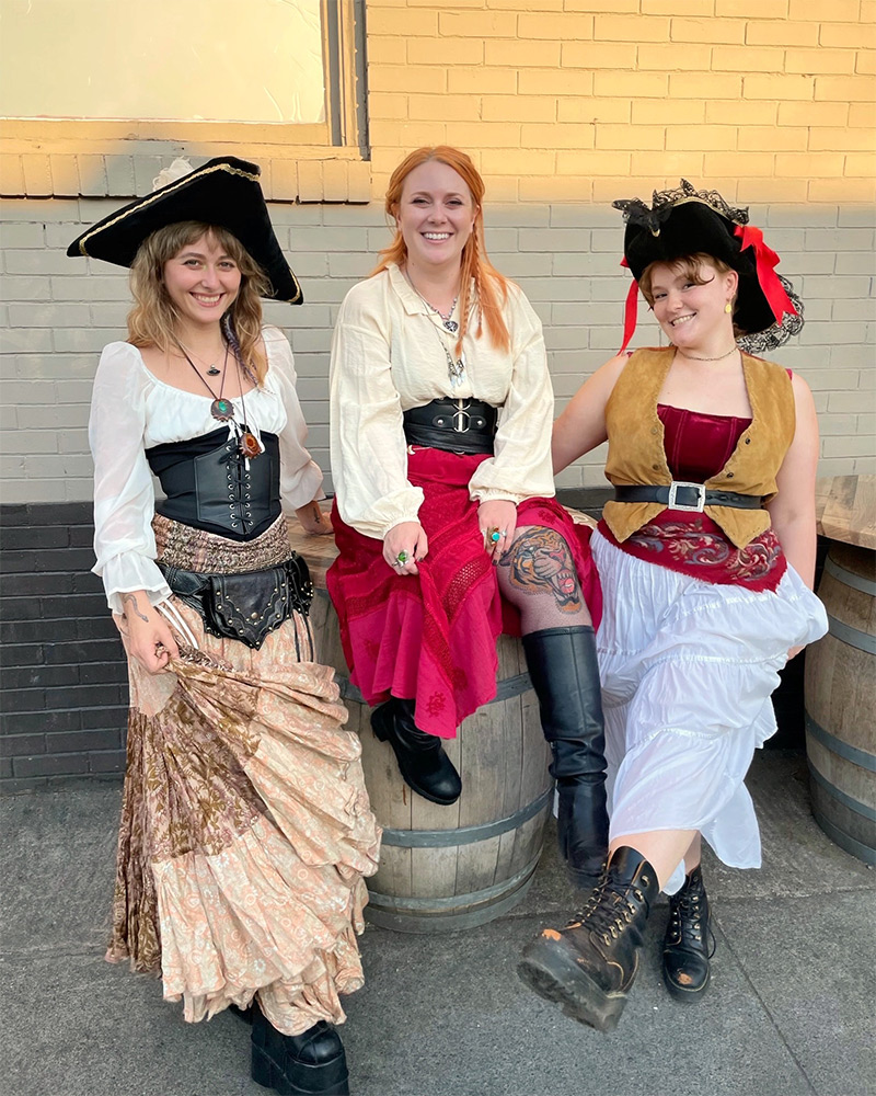 Three women in pirate Halloween costumes