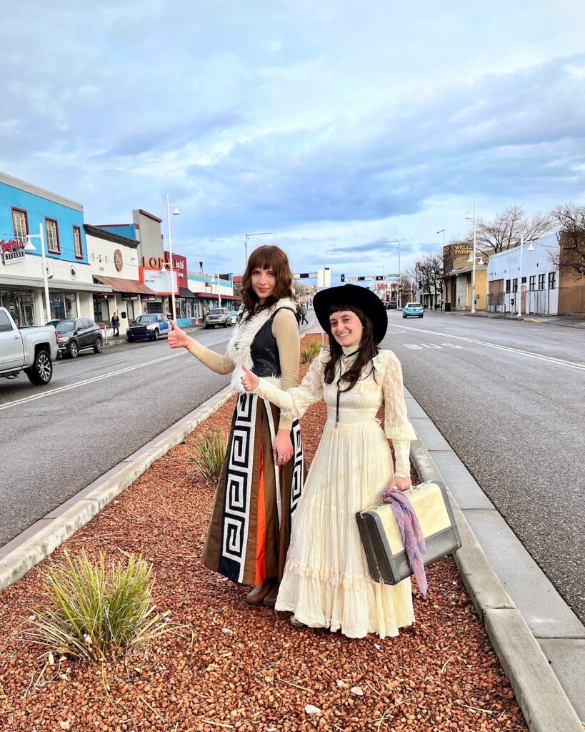 2024.02.17 NM1 (2) Two women dressed in 70s outfits hitchhike on the street