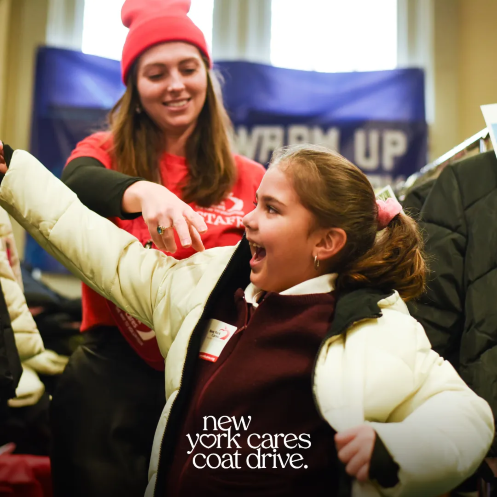 New York Cares Resized New York Cares volunteer helping child put on a coat