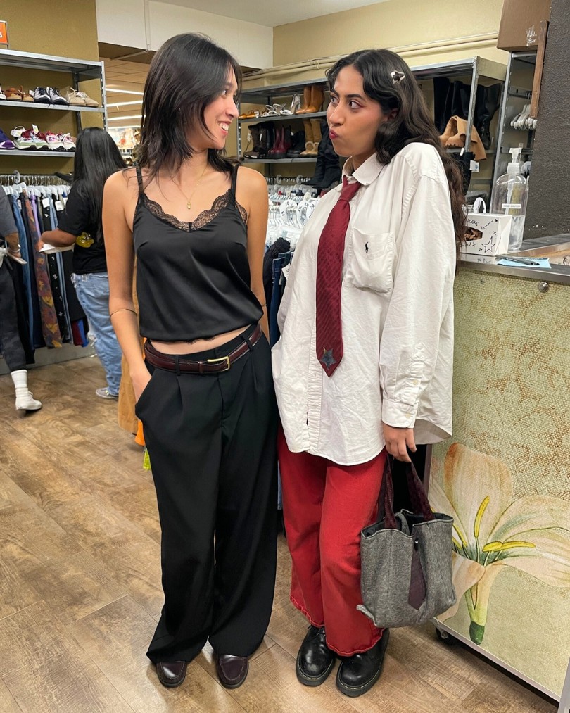 Customers in business casual - one in a black silk cami and low-rise slacks, the other in a white Ralph Lauren button down, red baggy jeans and a matching red tie Customers in business casual - one in a black silk cami and low-rise slacks, the other in a white Ralph Lauren button down, red baggy jeans and a matching red tie